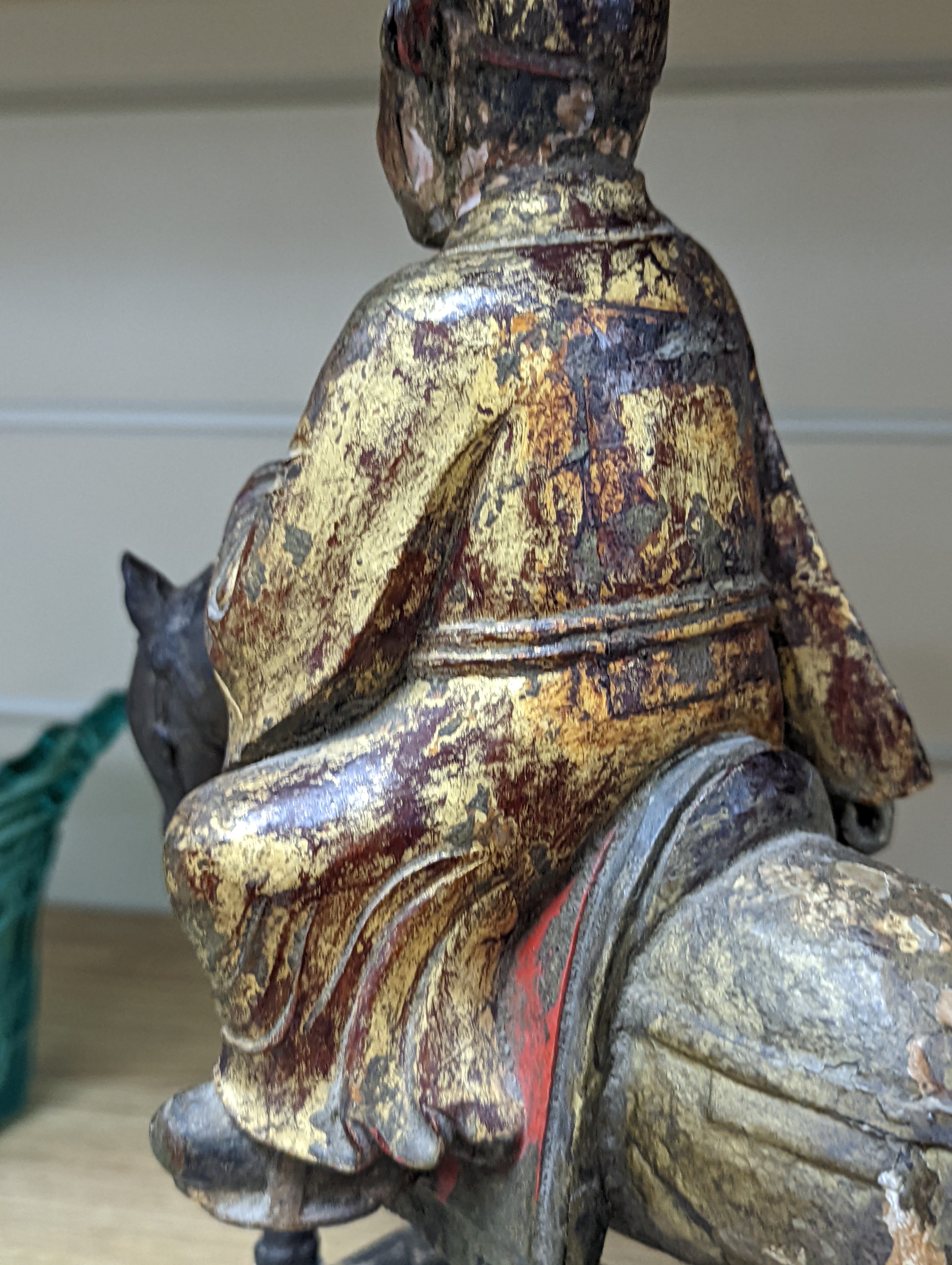 An 18th/19th century Chinese lacquered wood group of an official riding a horse, 30cm